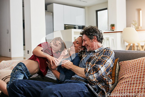 Image of Happy family, child and parents laughing for tickles on sofa in lounge with love, care and quality time to relax together. Mom, dad and boy playing funny game for comedy, happiness and joy at home