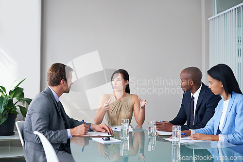 Image of Discussion, diversity and business people in a meeting in the office planning corporate project. Communication, teamwork and professional employees working in collaboration in the workplace boardroom