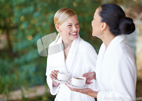 Image of Spa, coffee and women with a smile, bathrobe and relax with treatment, grooming and chilling. Female people, happy friends or girls with tea, happiness and pampering with wellness, laughing and funny