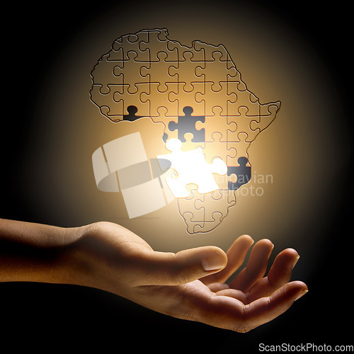 Image of Closeup, Africa and hand with a puzzle, development and problem solving for growth, future and planning. Zoom, fingers or person with symbol, solidarity and support for global innovation and solution