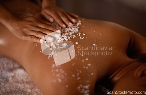 Image of Salt, spa scrub and beauty therapist hands with woman customer at a hotel with massage. Exfoliate therapy, luxury and relax treatment of a female person back for skincare and wellness exfoliation