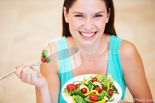 Image of Woman, portrait and eating a healthy salad with vegetables, nutrition and health benefits. Face of a happy female person on a nutritionist diet with vegan food for weight loss, wellness or detox