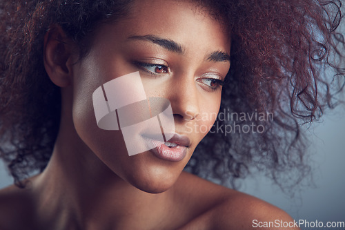 Image of African woman, curly hair and thinking in studio with makeup, cosmetics and vision by background. Girl, model and wellness with skincare, natural aesthetic and glow on face with beauty by backdrop