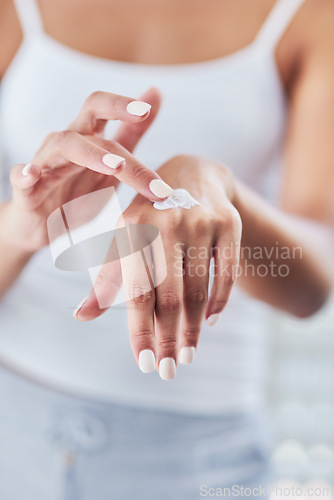 Image of Hands, skincare cream and woman moisturizing in home for healthy skin, beauty and hydration. Dermatology, hand and female model with creme product, lotion cosmetics or moisturizer oil with manicure.