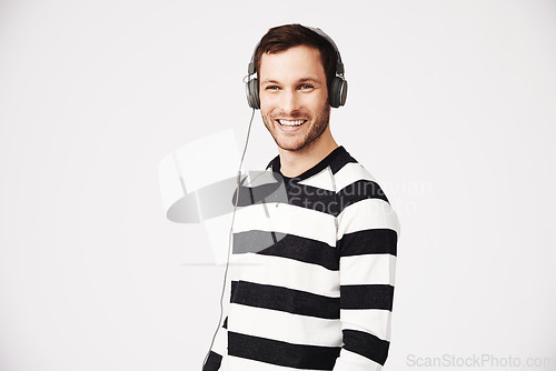 Image of Man, portrait and headphones with music and podcast with happiness and listening. Isolated, white background and male person hearing web audio and song streaming with a happy smile in studio