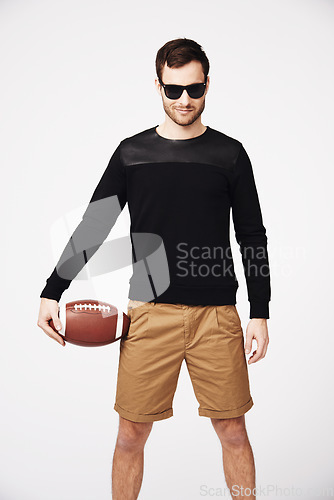 Image of Sunglasses, fashion and man in studio with football for confident, pride and stylish clothing. Fitness, sport and portrait of male person with ball in funky, cool and trendy style on white background