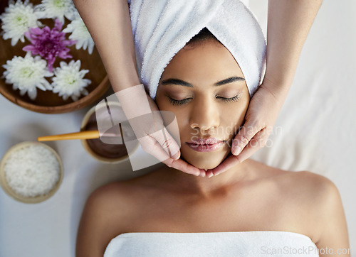 Image of Woman, hands and face sleeping in massage, skincare or beauty spa treatment on bed above at resort. Top view of female relaxing with eyes closed for calm therapy, healthy wellness or cosmetic facial