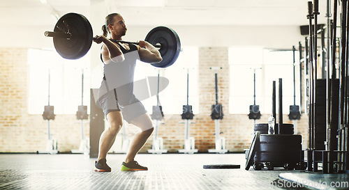 Image of Fitness, workout and man with barbell in gym for training, exercise and health. Sports, wellness and male athlete or strong bodybuilder lifting weights for body muscle, power and strength exercising.