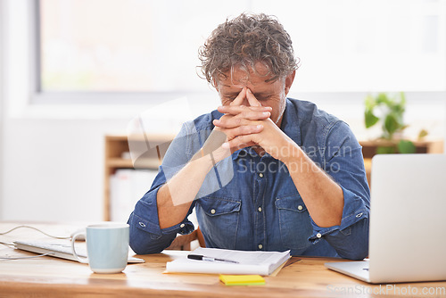 Image of Stress, anxiety and burnout with a business man in the office, sitting at his desk feeling worried about a deadline. Mental health, audit and debt with a male employee suffering from pressure at work