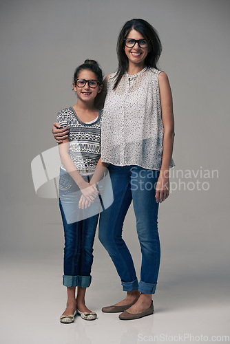 Image of Portrait, mother and girl embrace in studio together on gray background or happy, preteen daughter and mommy with glasses. Family love, single mom and child or loving mama relationship with care