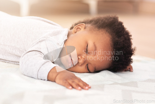 Image of Adorable, bed and baby sleeping in home on blanket for rest, nap time and dreaming in nursery. Childcare, newborn and cute, tired and African child in bedroom sleep for comfort, relaxing and calm