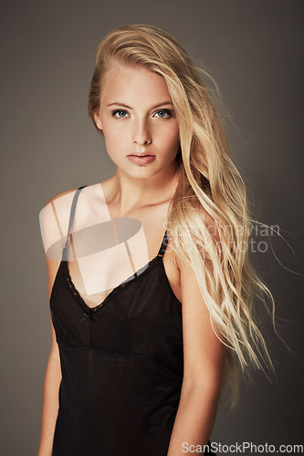 Image of Attractive, lingerie and portrait of a woman in nightwear isolated on a dark background in studio. Beautiful, sexy and a young model wearing evening clothes with confidence and sensuality on backdrop