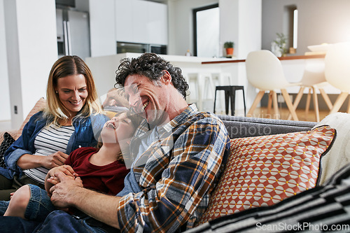 Image of Mother, father and kid laughing on sofa in living room for love, care and fun bonding together in family home. Happy young boy, cute child and relax with parents in lounge, happiness and smile
