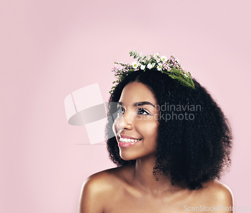 Image of Flowers, crown and woman thinking of beauty in studio, pink background and mockup of natural afro hair care. Face, happy african model and daydream with floral wreath, spring aesthetic and eco ideas