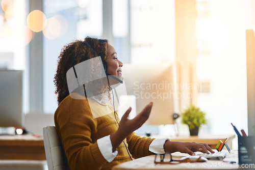 Image of Typing, chat or happy woman in call center speaking, consulting or talking at customer services. Virtual assistant, computer or friendly consultant in telemarketing or telecom company help desk