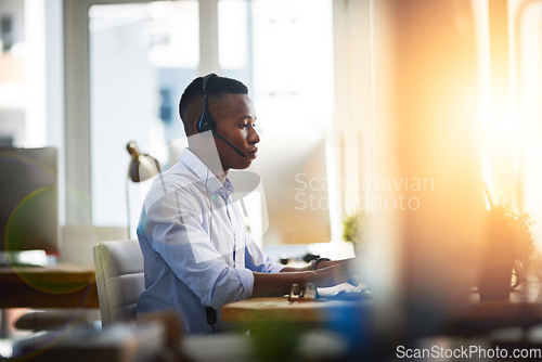 Image of Virtual assistant, consultant or black man typing in call center consulting online at customer services help desk. Contact us, email or African agent in telemarketing or telecom company in CRM office