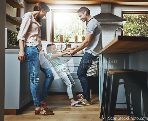 Image of Family, kitchen and dance together in home or bonding, child and father holdings hands, love and quality time in house. Girl, dad and mom with affection, fun and relax or dancing and laughing