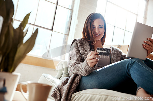 Image of Smile, tablet and credit card, happy woman on couch in living room and internet banking or fintech in home. Technology, online shopping payment and girl on sofa surfing retail website or digital shop