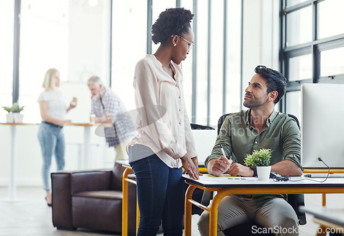 Image of Modern office, man and black woman coworking with discussion, smile and advice at start up design agency. Computer, desk and happy team leader with designer for help and creative opinion in workplace