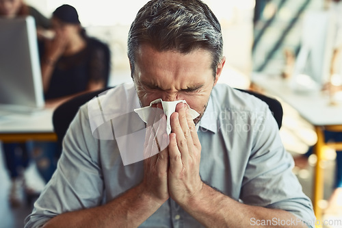 Image of Sick businessman, tissue and blowing nose with allergies, flu or fever from illness at the office. Man employee with cold virus, allergy or sinus in sneeze suffering disease or symptoms at workplace