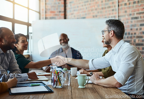 Image of Business people, meeting and handshake for deal, agreement and collaboration. Smile, shaking hands and employees in partnership, congratulations or b2b, group acquisition and thank you in office.