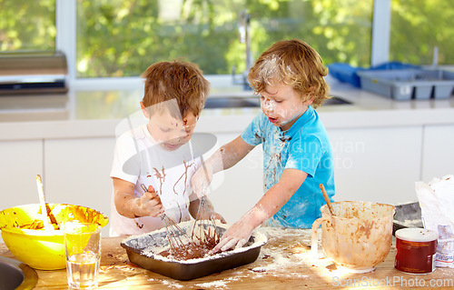 Image of Baking, children and messy friends in the kitchen together, having fun with ingredients while cooking. Kids, food and bake with naughty young brother siblings making a mess on a counter in their home