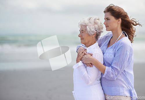 Image of Beach, young woman and her senior mother embrace or look at horizon outdoors. Mock up, free and hugging elderly woman with adult daughter or at sea or ocean thinking for affection and leisure