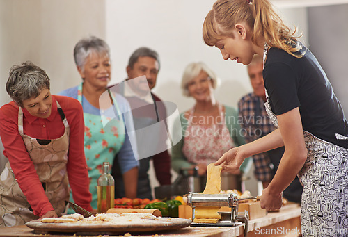 Image of Food, senior cooking class and a woman teaching people in the kitchen of a home for meal preparation. Pasta maker, equipment and learning with mature friends watching a female chef follow a recipe