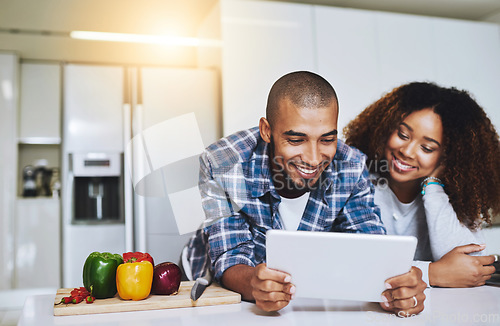 Image of Couple, tablet and cooking with recipe in kitchen at home for food blog, internet website and online connection. Happy man, woman and digital technology for reading healthy vegan meal instructions