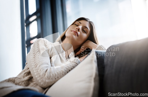 Image of Relax, sleeping woman and living room couch at home with a nap and feeling calm. Sofa, house and lounge of a young female person in a apartment with rest and eyes closed dreaming from day off