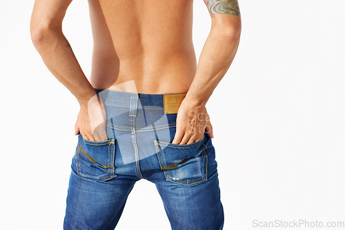 Image of Jeans, back and a man in studio with hands in pocket for sexy pose, clothes and denim. Male fashion model person posing topless isolated on a white background for style, sports body and designer wear