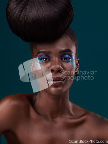 Image of Portrait, hair care and makeup with a model black woman in studio on a blue background for fashion. Face, hairstyle and cosmetics with a beautiful young female person at a salon for beauty or styling