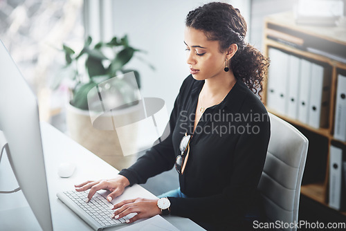 Image of Business, typing and a woman with an email on a computer, research or secretary work. Analytics, desk and African female receptionist with pc in an office for communication, connectivity and working