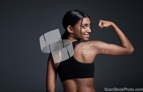 Image of Portrait, happy and woman flexing back in studio isolated on a black background mockup. Strong flex, smile and Indian female athlete with bicep, arm strength or bodybuilder muscle, fitness or workout