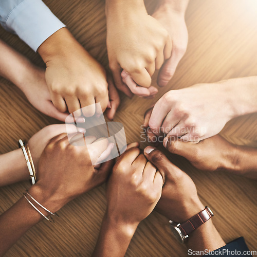 Image of Community, trust and friends holding hands by table at group counseling or therapy session. Gratitude, love and top view of people in circle for praying together for religion, community and connect.