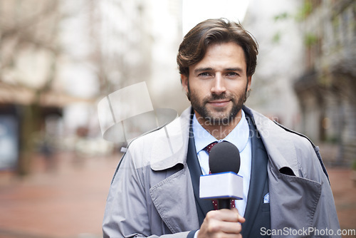 Image of Portrait, broadcast and a man with a microphone in the city for an interview or tv journalist. Smile, media and a male reporter talking with a mic for press, anchor job and reporting the news