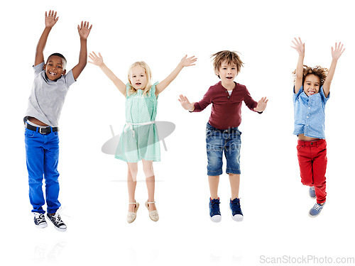 Image of Happy, jumping and portrait of children in studio for diversity, friends and playing. Happiness, youth and smile with group of kids isolated on white background for celebration, playful and energy