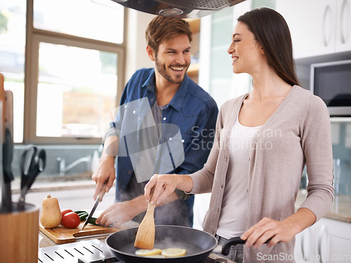 Image of Happy couple, food and cooking together in a pan in the kitchen with healthy organic ingredients for dinner at home. Man helping woman with smile in happiness making meal with vegetables on stove