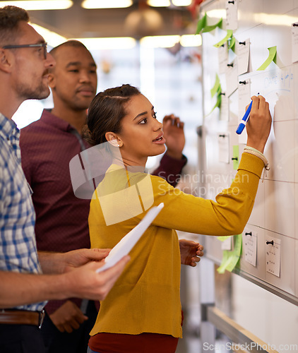 Image of Woman, focus and brainstorm on whiteboard or marketing presentation or male employees and in office. Coach, lady trainer and man workers or flip chart or business project and workplace meeting