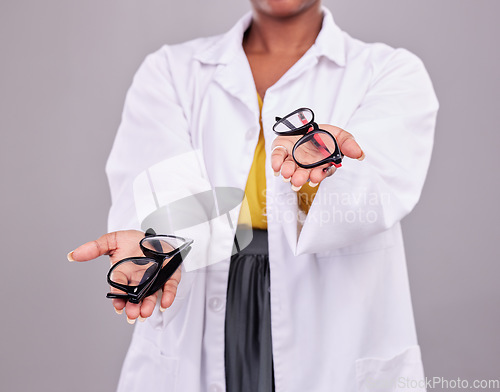 Image of Glasses in hands, choice and vision with eye care, prescription lens and frame isolated on studio background. Person with eyewear, optometry and health insurance, product to help with eyesight