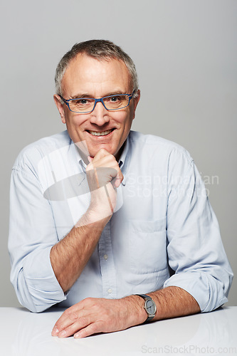 Image of Portrait, business and mature man with a smile, confident and manager against a studio background. Face, happy male person and employee with happiness, skills and professional with career and success