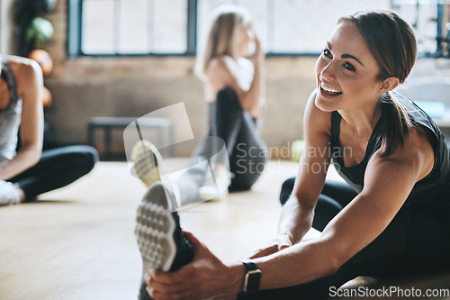 Image of Fitness, gym and women stretching, exercise and workout goal for wellness, balance and stress relief. Female people, girls and athletes on the floor, stretch legs and smile with training and health