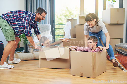 Image of Child, happiness and boxes with family moving in apartment for fun and enjoyment on the floor. Parents, happy and children excited in a box at family home for investment and a lifestyle with love.