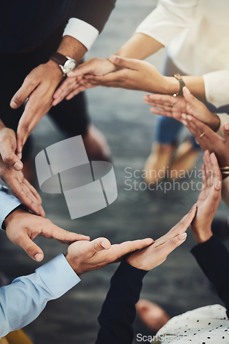 Image of Teamwork, solidarity and business people with their hands together in a circle for unity. Collaboration, friends and top view of multiracial employees with connection for team building in the office.