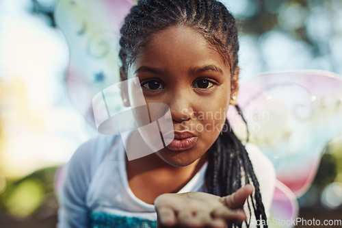 Image of Kiss, princess costume and portrait of girl in forest for playing fantasy, childhood game and happiness. Nature, fairy tale and face of happy child in woods blowing kisses for love, magic and cute