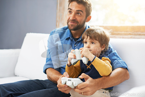 Image of Video games, father and son on a couch, playing and bonding for quality time, home and relax. Family, happy dad and boy with parent, male child and kid with controller, happiness and entertainment