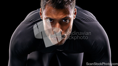 Image of Portrait, isolated runner and man ready to run, start race and intense focus in dark studio background. Serious, man and running or athlete, cardio or training motivation to win, workout or exercise