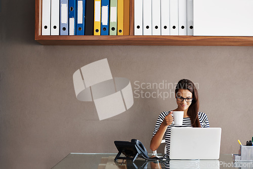 Image of Laptop, coffee and business woman in office for planning, management and checking email against wall background. Tea, relax and female manager online for project, proposal or creative idea research