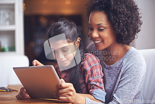 Image of Family, children or tablet with a mother and daughter busy with homework for education in the home together. Love, study or technology with a parent and female child bonding while learning in a house