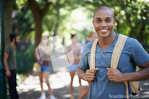 Image of Man, student and portrait with backpack by a campus park with a smile and ready for study. Happiness, young and African male face in college and university outdoor with education and school bag